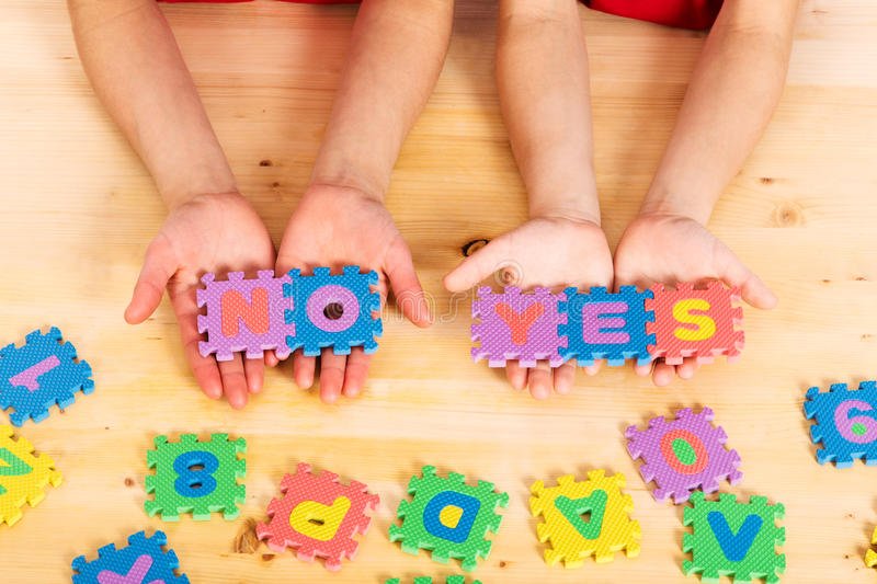 puzzle-letters-yes-no-colorful-foam-words-kid-s-hands-wooden-background-51947031